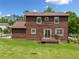 Back exterior with a spacious yard and a wood deck, perfect for outdoor gatherings at 893 Sandune Dr, Norcross, GA 30093