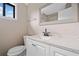 Updated bathroom with a white vanity, modern faucet, and a stylish, framed mirror at 893 Sandune Dr, Norcross, GA 30093