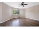 Spacious bedroom with neutral walls, ceiling fan, and dark wood-look flooring at 893 Sandune Dr, Norcross, GA 30093
