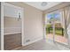 Dining area featuring new floors, sliding glass door to outdoor deck, and access to dining room at 893 Sandune Dr, Norcross, GA 30093