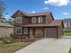 Beautiful two-story home with stone accents, attached garage, and a well-maintained front yard at 893 Sandune Dr, Norcross, GA 30093