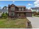 Attractive two-story home with landscaped front yard, stone facade, and attached garage at 893 Sandune Dr, Norcross, GA 30093