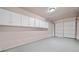 Spacious garage with cabinets for storage and an automatic garage door at 893 Sandune Dr, Norcross, GA 30093