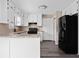 Kitchen with black appliances, granite countertops, white cabinets, and stainless steel fixtures at 893 Sandune Dr, Norcross, GA 30093
