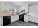 Kitchen with black appliances, granite countertops, white cabinets, and stainless steel fixtures at 893 Sandune Dr, Norcross, GA 30093