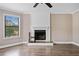 Bright living room with hardwood floors, a fireplace, large windows, and a ceiling fan at 893 Sandune Dr, Norcross, GA 30093
