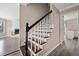 Elegant staircase with dark wood treads and white risers, complemented by modern gray walls at 893 Sandune Dr, Norcross, GA 30093