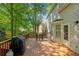 Back deck with grill and seating area that has a view of the expansive backyard and mature trees at 1025 Taylor Oaks Dr, Roswell, GA 30076