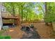 Backyard with elevated deck and patio seating area with fire pit at 1025 Taylor Oaks Dr, Roswell, GA 30076