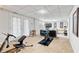 Finished basement includes exercise area with equipment and french doors to the outside at 1025 Taylor Oaks Dr, Roswell, GA 30076