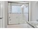 This bathroom features a tub and shower combination with glass sliding doors and tile surround at 1025 Taylor Oaks Dr, Roswell, GA 30076