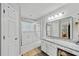 Bathroom features a granite countertop, a large mirror, and a shower/tub combo with glass doors at 1025 Taylor Oaks Dr, Roswell, GA 30076
