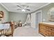 Bedroom with grey accent wall, carpeted floor, and modern ceiling fan at 1025 Taylor Oaks Dr, Roswell, GA 30076