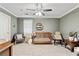 Bedroom with grey accent wall, carpeted floor, and a modern ceiling fan at 1025 Taylor Oaks Dr, Roswell, GA 30076