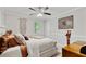 Bedroom with a ceiling fan, neutral paint, and an accent wall at 1025 Taylor Oaks Dr, Roswell, GA 30076