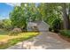 Charming home with a well-manicured lawn, mature landscaping, and a welcoming front porch at 1025 Taylor Oaks Dr, Roswell, GA 30076