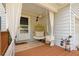 Cozy front porch with curtains, egg chair swing, and stylish decor at 1025 Taylor Oaks Dr, Roswell, GA 30076