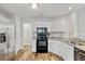 Modern kitchen with white cabinets, stainless steel appliances, and granite countertops at 1025 Taylor Oaks Dr, Roswell, GA 30076