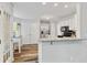 Bright kitchen features white cabinets, stainless steel appliances, and wood floors at 1025 Taylor Oaks Dr, Roswell, GA 30076