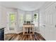 Bright breakfast nook with natural light, hanging plants and wood floors at 1025 Taylor Oaks Dr, Roswell, GA 30076