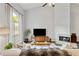 Bright living room with high ceilings, a fireplace, and a large window at 1025 Taylor Oaks Dr, Roswell, GA 30076
