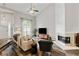 Bright living room with high ceilings, fireplace, and a large window at 1025 Taylor Oaks Dr, Roswell, GA 30076