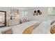 A well-lit main bedroom with a modern dresser, wall decor, and large windows at 1025 Taylor Oaks Dr, Roswell, GA 30076