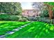 Beautiful backyard with lush green lawn, stone pathway, and elegant home at 15 Cherokee Nw Rd, Atlanta, GA 30305