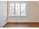 Bedroom featuring a large window with white trim and beautiful hardwood floors at 15 Cherokee Nw Rd, Atlanta, GA 30305