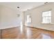 Bright bedroom featuring hardwood floors, white walls and trim, and large windows at 15 Cherokee Nw Rd, Atlanta, GA 30305
