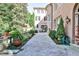 Picturesque courtyard with stone pathways, lush greenery, and a serene seating area at 15 Cherokee Nw Rd, Atlanta, GA 30305