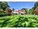 Elegant Mediterranean-style home with a well-manicured lawn and symmetrical landscaping, showcasing its curb appeal at 15 Cherokee Nw Rd, Atlanta, GA 30305
