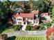 Aerial view of a grand estate with a terracotta roof, lush gardens, and a circular driveway, exuding luxury at 15 Cherokee Nw Rd, Atlanta, GA 30305