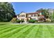 Beautiful exterior view of home with a vast lawn, mature trees, and manicured landscaping at 15 Cherokee Nw Rd, Atlanta, GA 30305