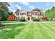 Elegant home featuring a sprawling lawn, manicured landscaping, and a classic Mediterranean-style facade at 15 Cherokee Nw Rd, Atlanta, GA 30305
