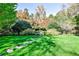 Expansive manicured garden with vibrant trees, lush lawn, and peaceful atmosphere at 15 Cherokee Nw Rd, Atlanta, GA 30305