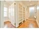 Hallway featuring hardwood floors, an open door, and built-in shelving for storage at 15 Cherokee Nw Rd, Atlanta, GA 30305