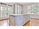 Elegant kitchen island with light-colored cabinets, marble countertop, and stainless steel fixtures at 15 Cherokee Nw Rd, Atlanta, GA 30305