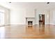 Elegant living room with hardwood floors, a fireplace, and a doorway with a view into a sunroom at 15 Cherokee Nw Rd, Atlanta, GA 30305