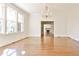 Spacious living room with hardwood floors and large windows, offering natural light and a view to the fireplace at 15 Cherokee Nw Rd, Atlanta, GA 30305