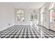 Bright living area with a distinctive black and white checkered floor, arched windows, and elegant trim at 15 Cherokee Nw Rd, Atlanta, GA 30305