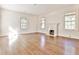 Large room with fireplace, hardwood floors, and several windows providing ample natural light at 15 Cherokee Nw Rd, Atlanta, GA 30305