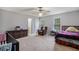 Bright bedroom with a ceiling fan, multiple windows, and neutral carpet, providing a serene atmosphere at 2730 Milton Bryan Dr, Loganville, GA 30052
