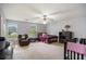 Spacious bedroom featuring a ceiling fan, windows for natural light, and ample room for a bed, furniture, and crib at 2730 Milton Bryan Dr, Loganville, GA 30052
