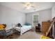 Well-lit bedroom with a ceiling fan, natural light, and classic wood trim, offering a cozy atmosphere at 2730 Milton Bryan Dr, Loganville, GA 30052
