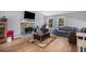 Inviting living room with a cozy stone fireplace, hardwood floors, and large windows offering ample natural light at 2730 Milton Bryan Dr, Loganville, GA 30052