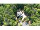 Aerial view of a secluded home surrounded by lush greenery, featuring a private driveway and well-manicured landscaping at 310 Anders Path, Marietta, GA 30064