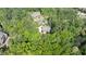 Aerial view of a house nestled among lush trees, featuring a private driveway and serene surroundings offering seclusion and privacy at 310 Anders Path, Marietta, GA 30064