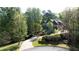 Aerial view of a luxurious home surrounded by lush greenery, showcasing the property's serene and private setting at 310 Anders Path, Marietta, GA 30064