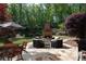Backyard patio with stone flooring, fireplace, seating, and dining area at 310 Anders Path, Marietta, GA 30064